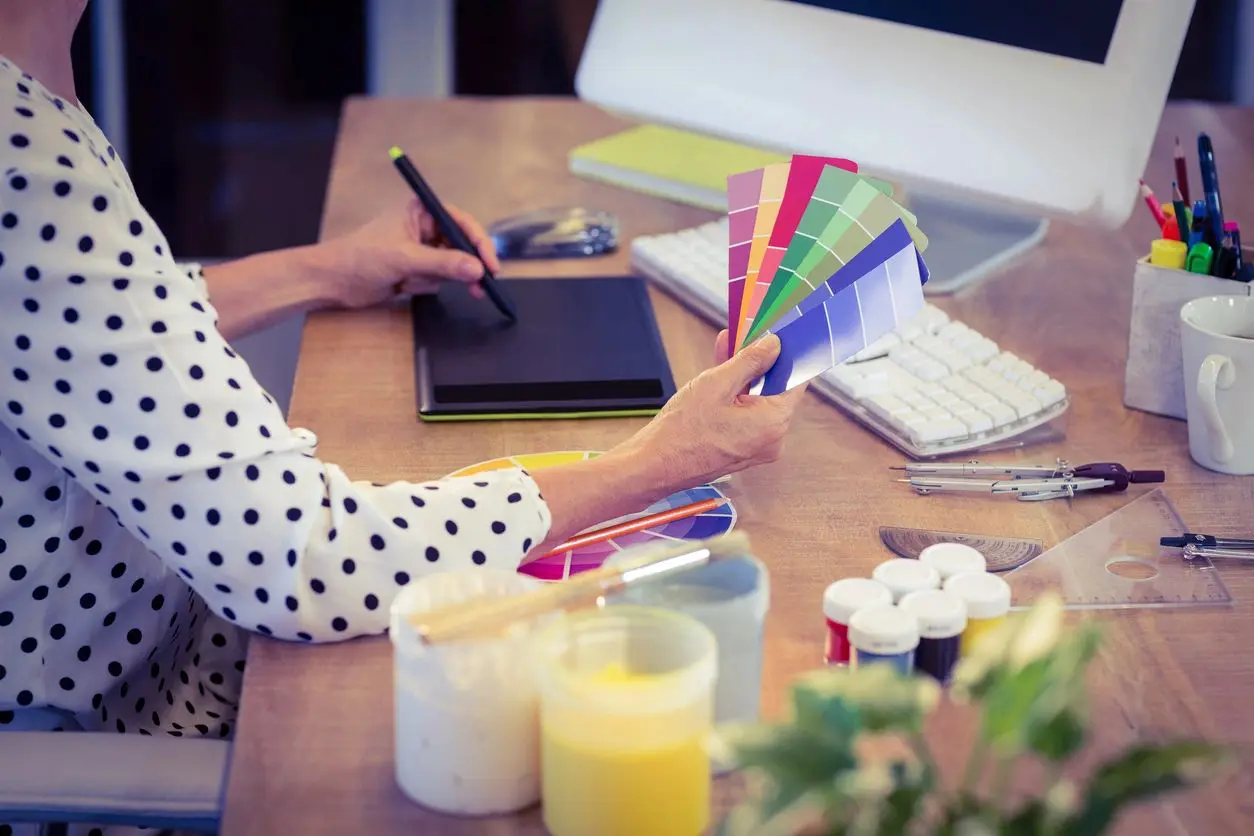 lady drawing using pen on computer